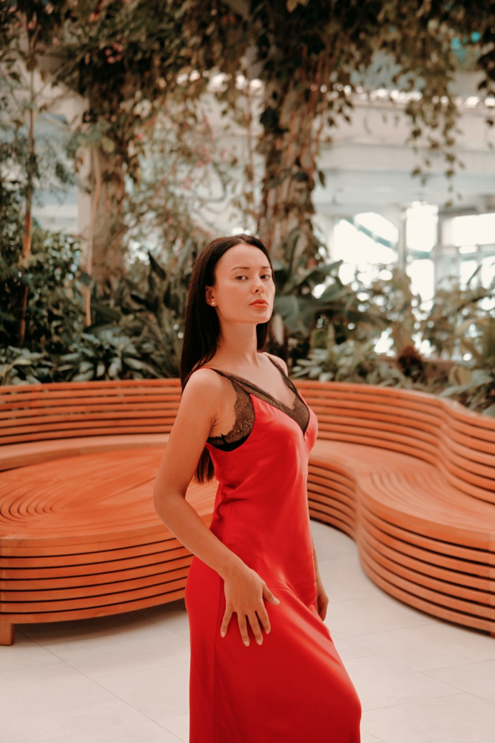 standing woman wearing red dress