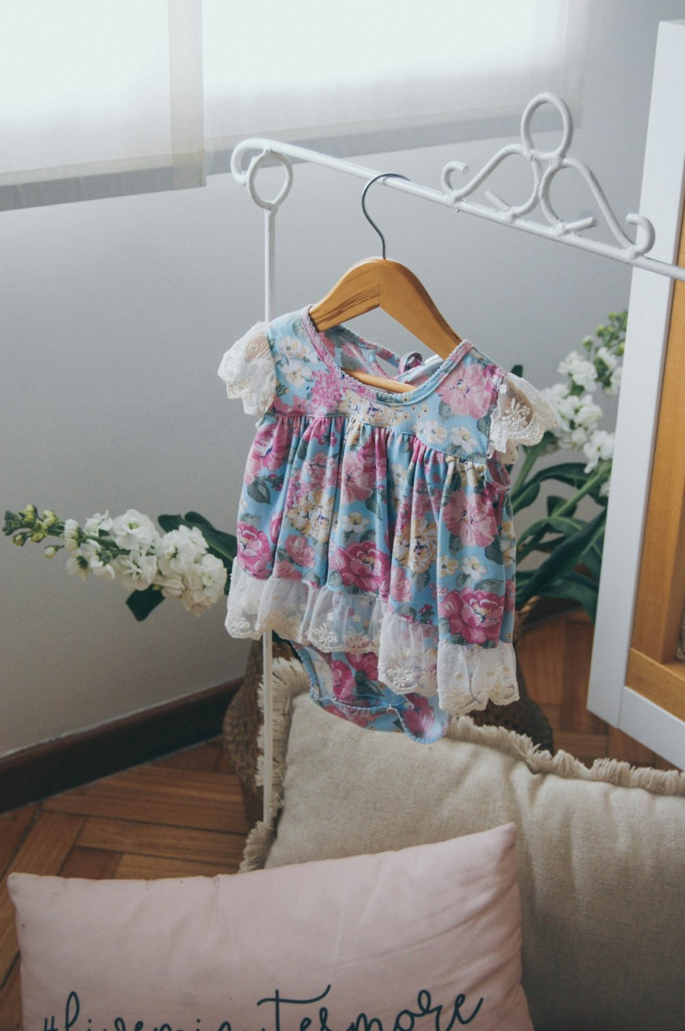 toddler's multicolored floral onesie on hanger