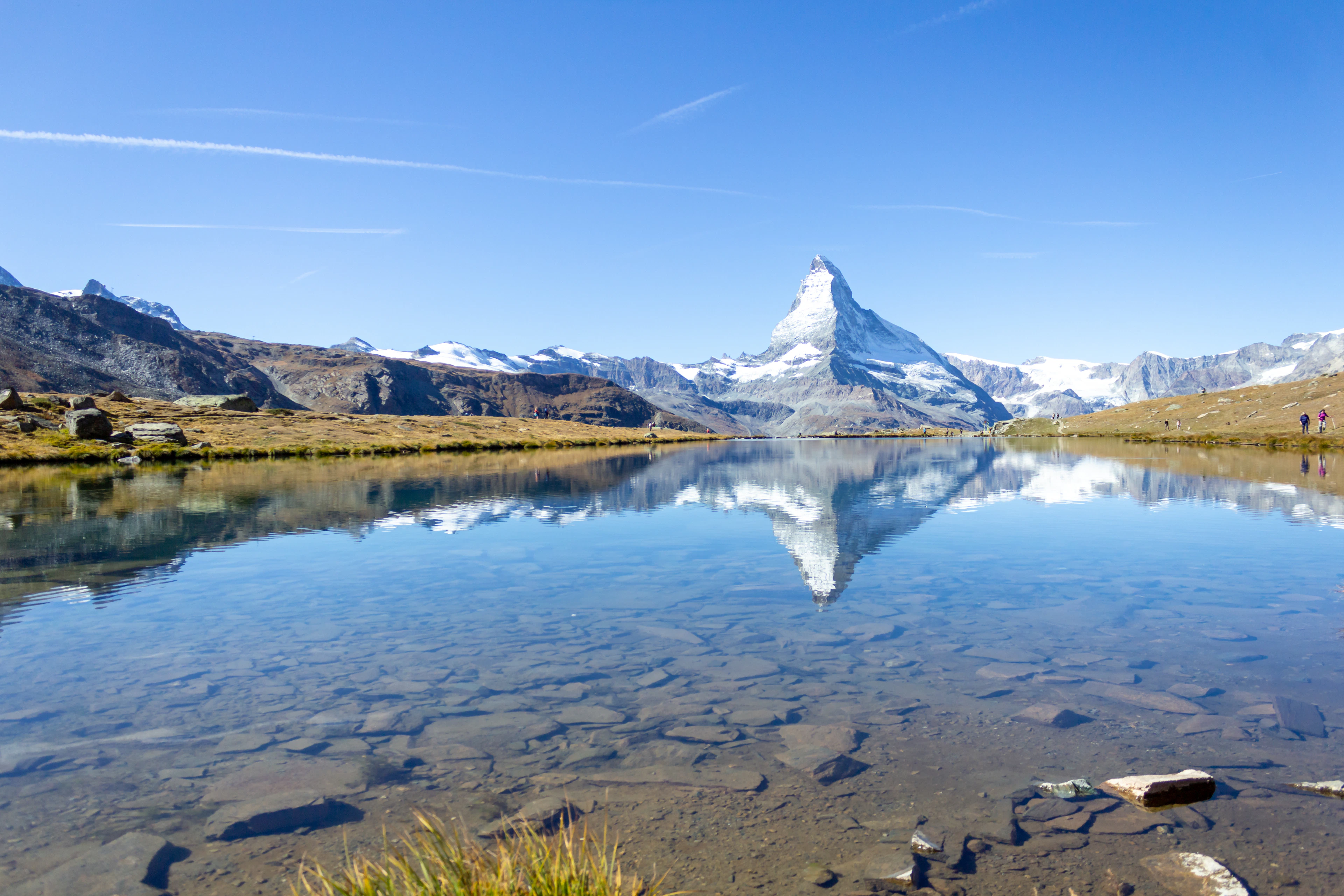 The Matterhorn reflected in a still mountain lake, a highlight of hiking Zermatt