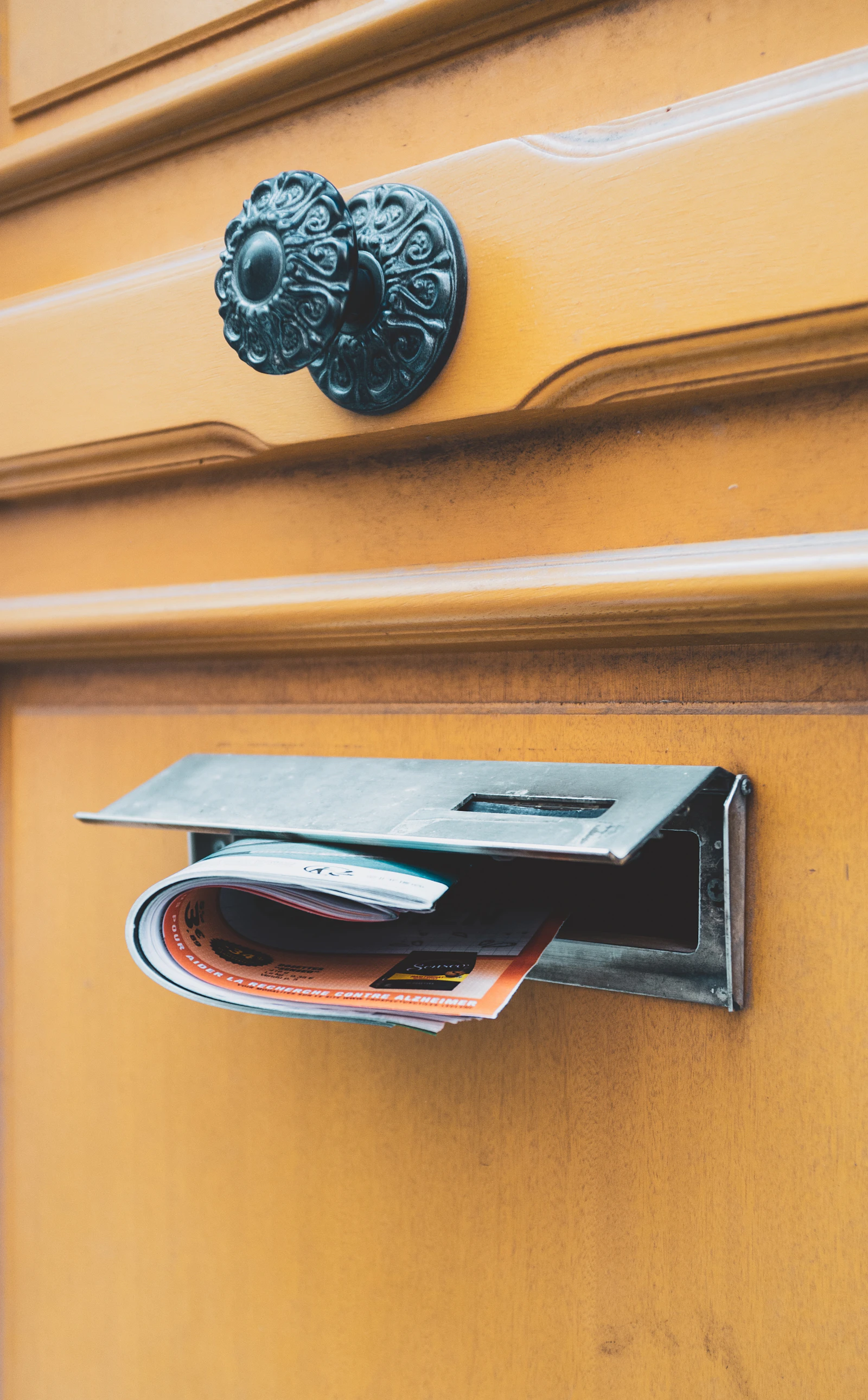 Courrier glissé dans la fente d'une porte, illustration du nom légal à garder sur la boîte aux lettres après le mariage