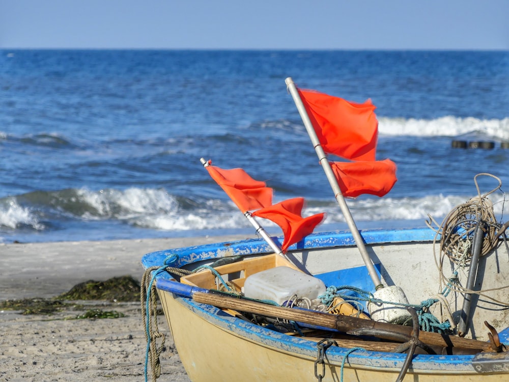 white and brown boat on the seashore