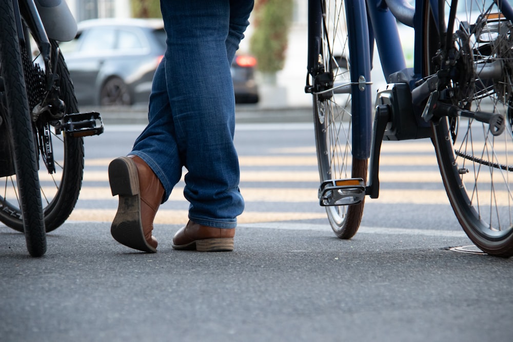 person standing beside bicycles during daytime