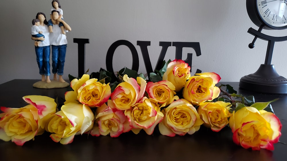 yellow rose flower with LOVE free standing letters