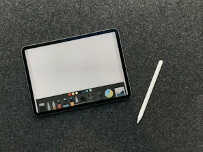 User interacting with a tablet displaying an AI-powered creative application interface.