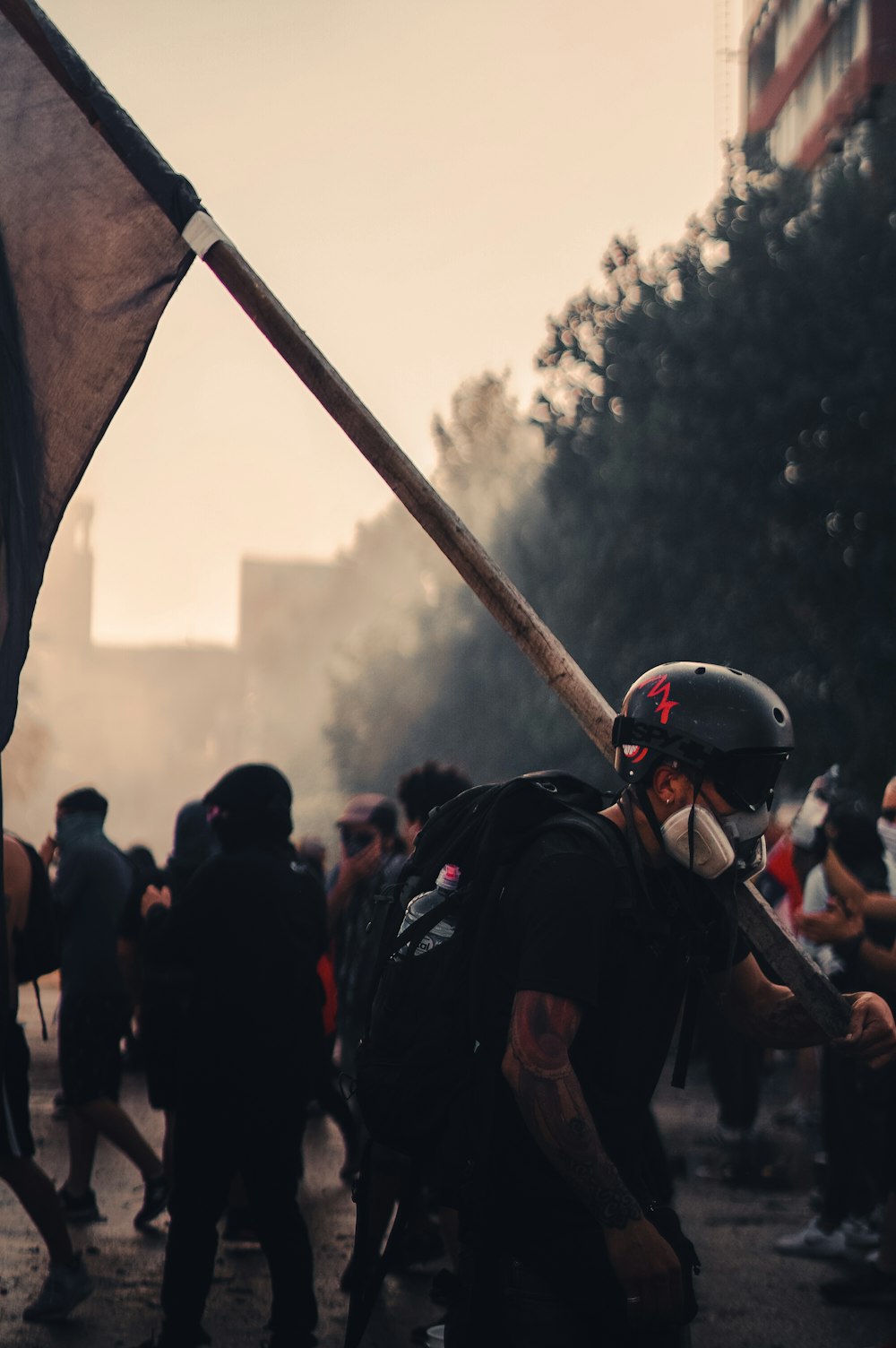 man holding flag by building