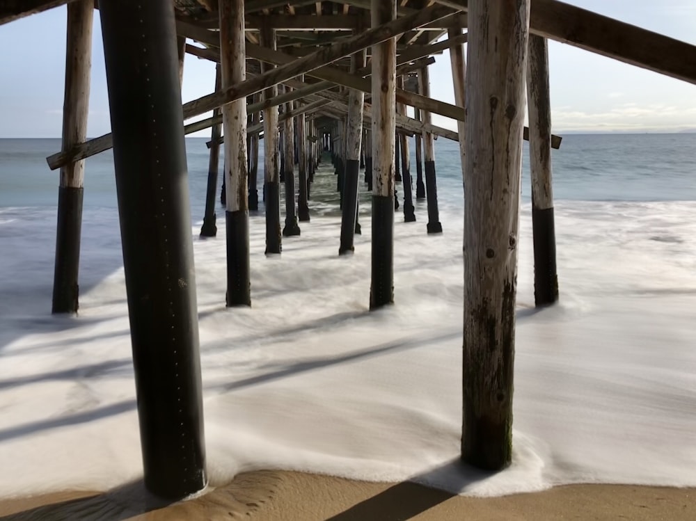 white wooden sea dock post