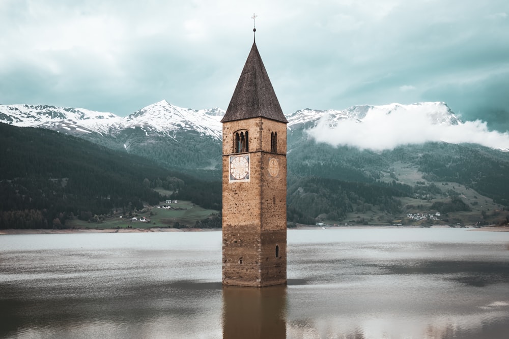 brown concrete tower on body of water during daytime