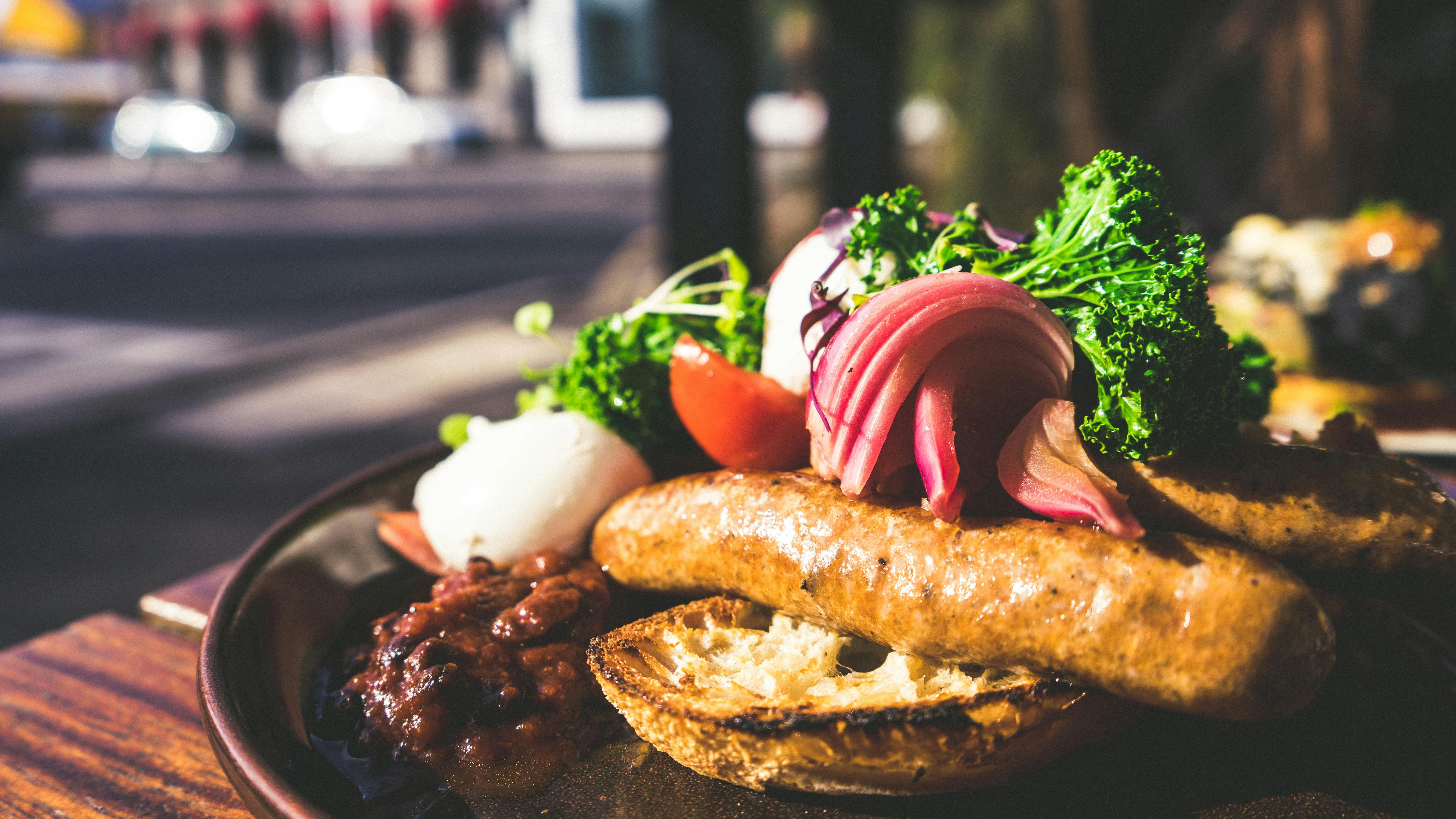 cooked sausage with broccoli and beans on plate