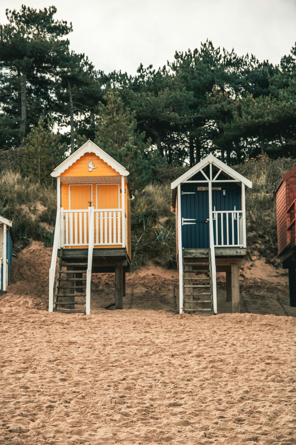 two yellow and blue closed house on beach