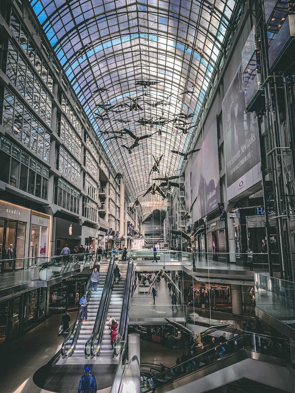 people riding escalators inside building