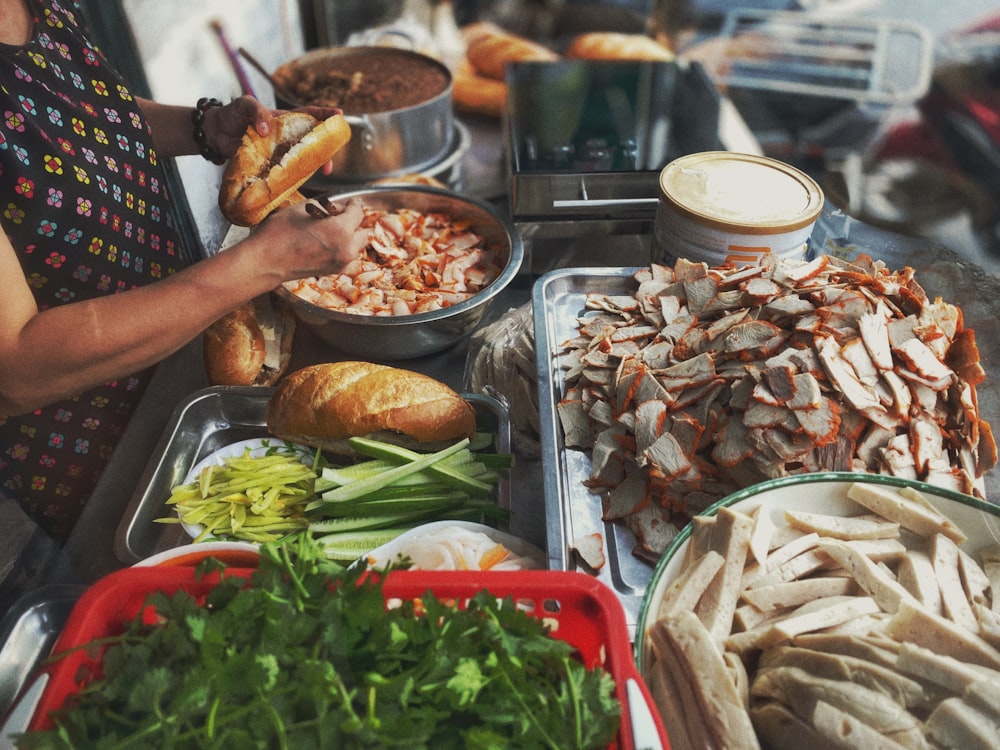 person standing near sliced vegetables