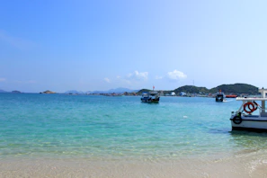 Crystal-clear turquoise waters surrounding the Gili Islands with boats anchored gently