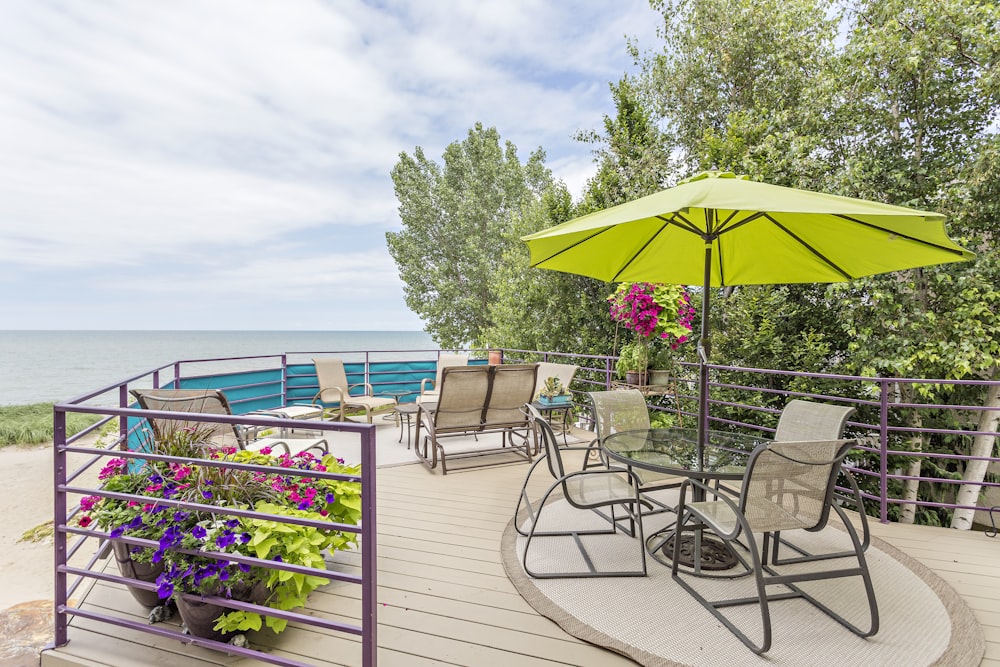 yellow patio set near green trees during daytime