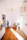 Entryway with a dual-layer scrap mat in earthy colors, sunlight streaming in from the door.
