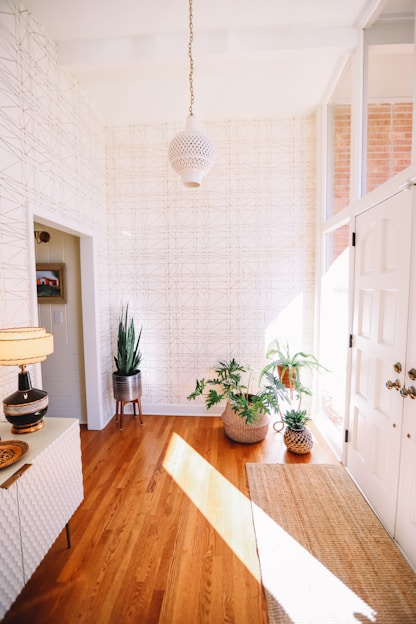 A cozy entryway featuring a solid wood shoe rack neatly holding various shoes, with soft natural light highlighting the organized space.