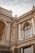 A detailed architectural structure featuring classic and ornate decorative elements, including columns, arched windows, and intricate carvings on a facade. The building exhibits a historic and elegant design with light beige and brown tones.