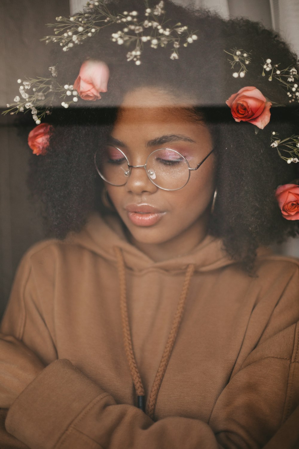 woman wearing floral headdress and brown pullover hoodie