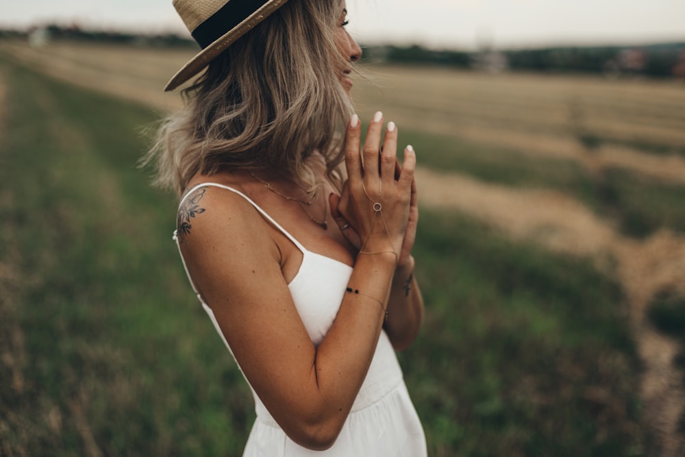 selective photo of woman in white spaghetti-strap dress