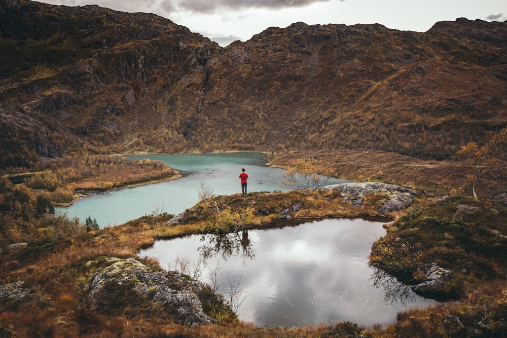 person standing beside body of water during daytime