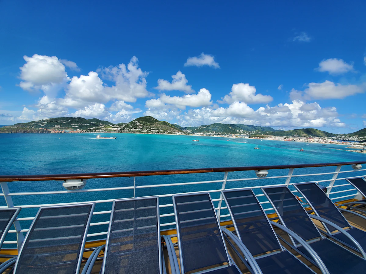 A cruise ship sailing near a tropical beach