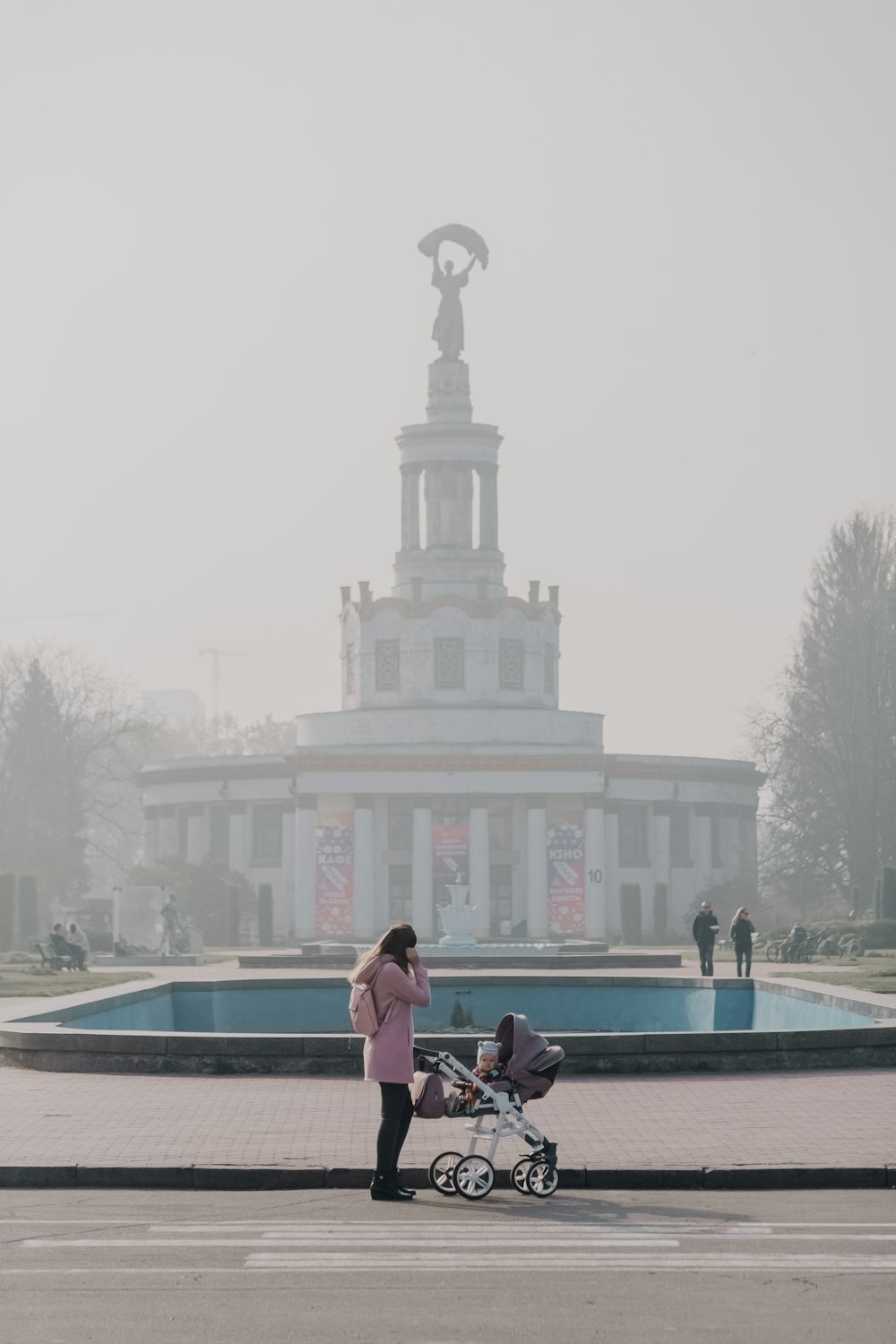 woman standing beside stroller