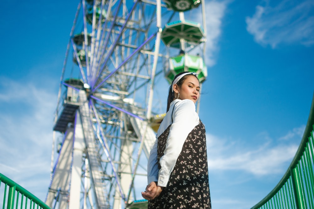 woman standing near ferris wheel