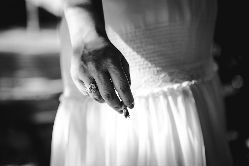a close up of a person holding a ring