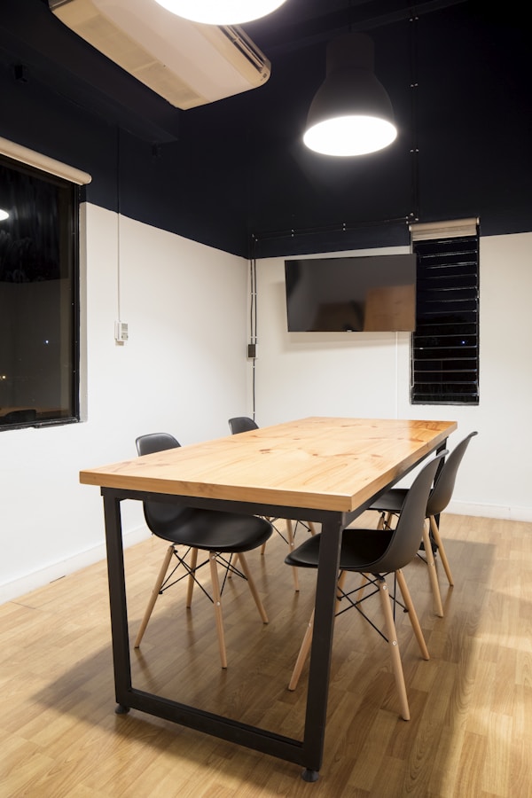 Wooden table in a meeting room and TVby Slidebean