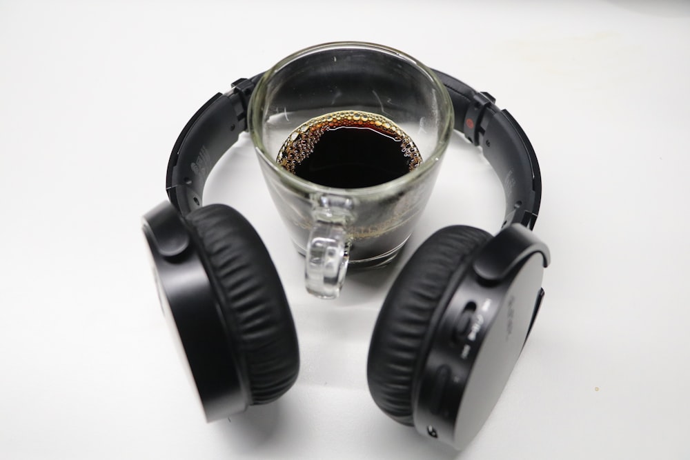 black wireless headphones near mug