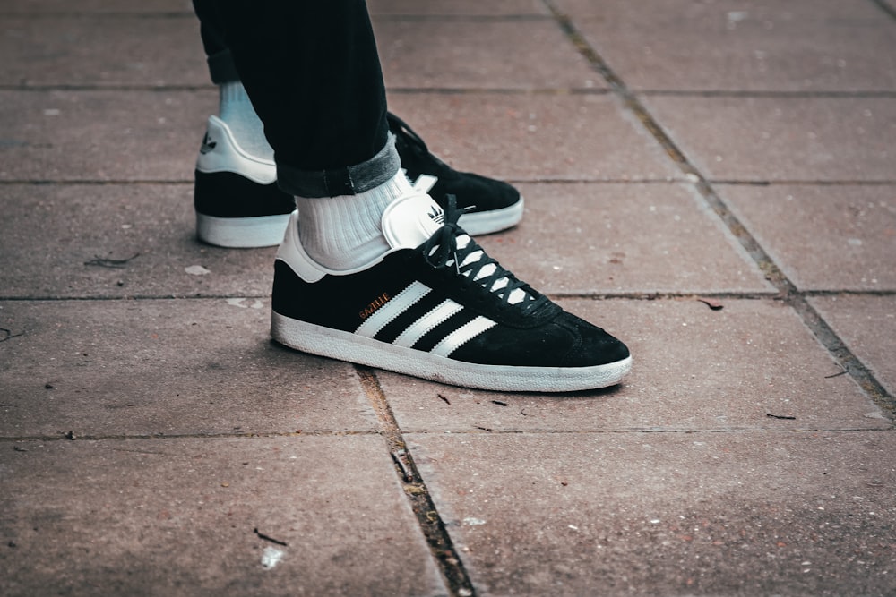 Person wearing black-and-white adidas low-top sneakers photo – Free Uk  Image on Unsplash