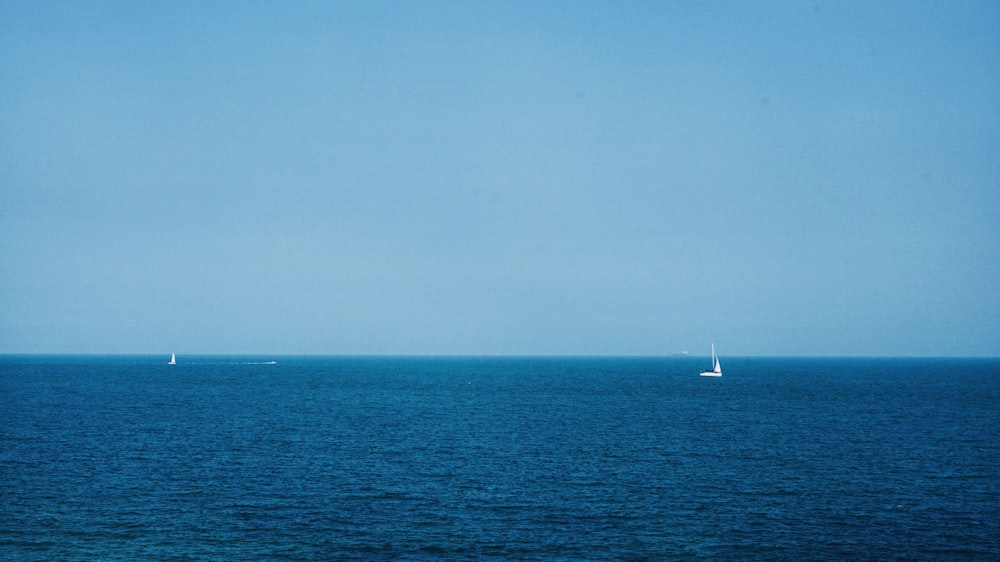 white boat on calm ocean