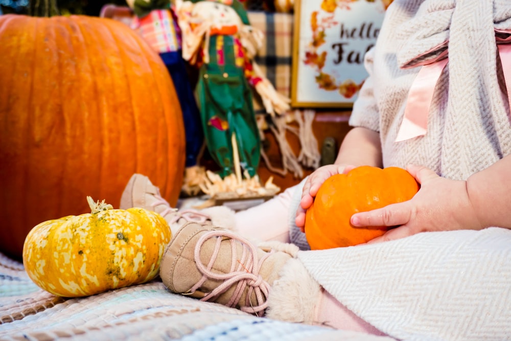 sitting toddler holding orange squash