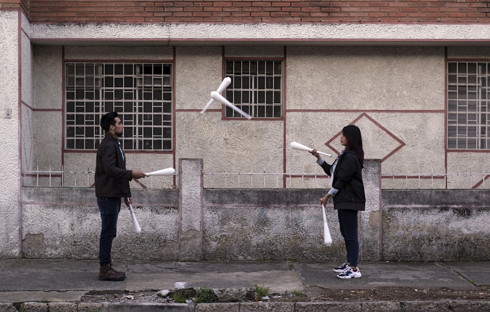 man and woman near house