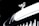 A close-up of a luxury car's hood ornament, featuring a sleek metallic emblem with intricate detailing. The background is dark, highlighting the shiny, reflective surface of the ornament.