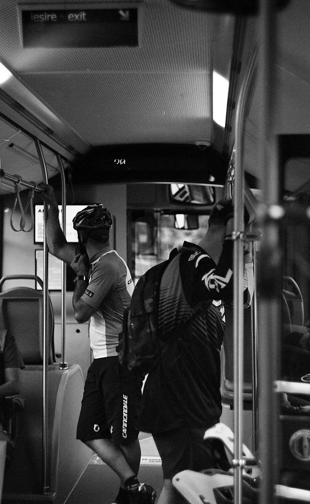 greyscale photo of men inside train