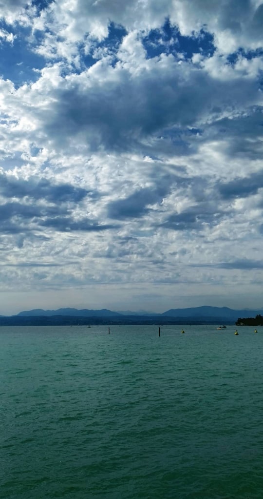 calm body of water under cloudy sky in Sirmione Italy