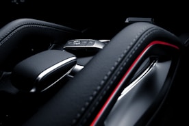 Close-up of a technician programming a car key with specialized equipment.