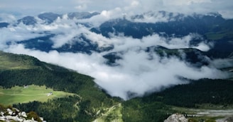 A breathtaking view of lush green mountains with a misty backdrop, symbolizing the beauty of Rwanda's landscapes.