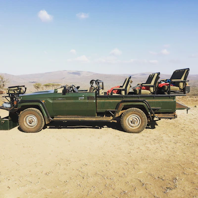 A sleek Toyota Coaster bus parked ready for group travel under a clear blue sky.