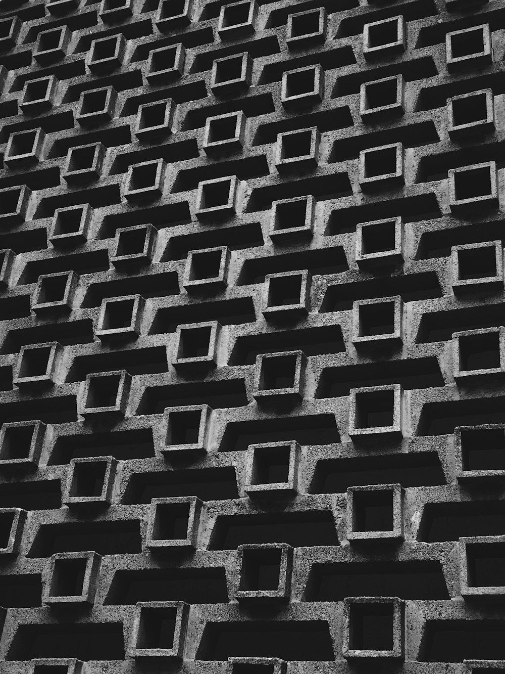 a black and white photo of a brick wall