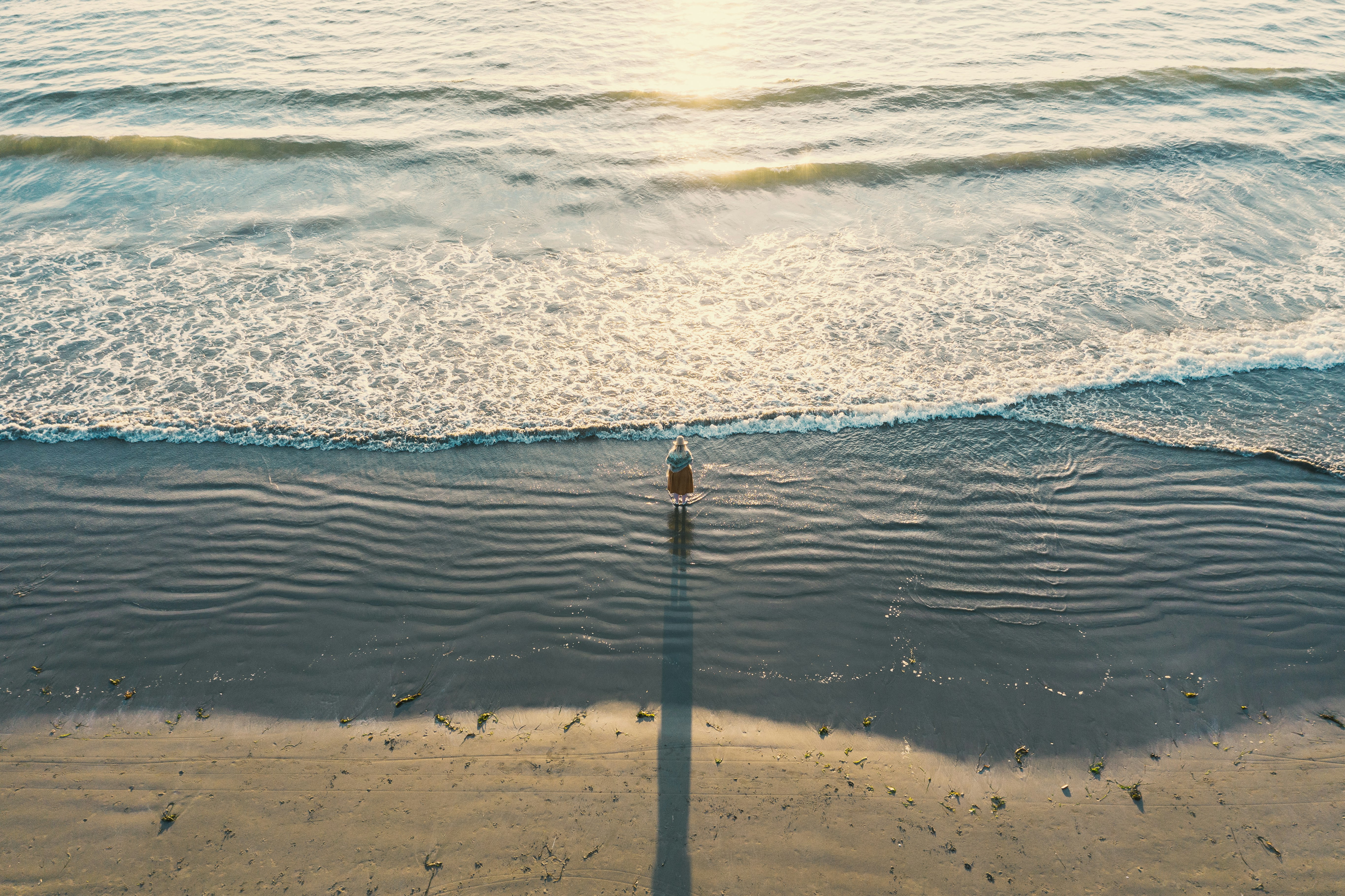 aerial photography of person near seashore during daytime