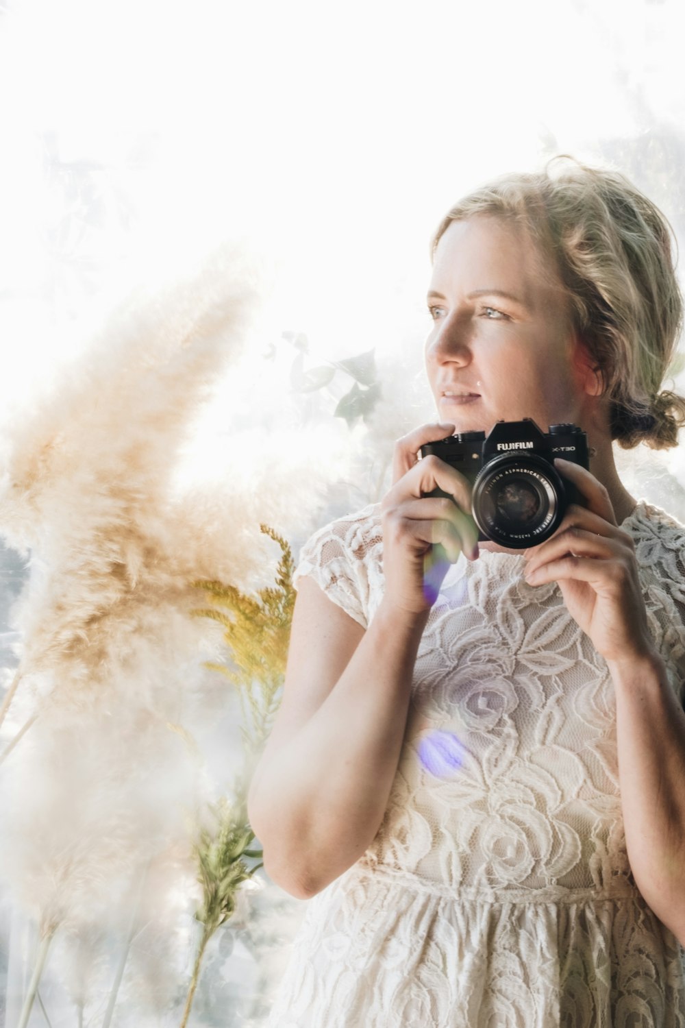 woman holding DSLR camera