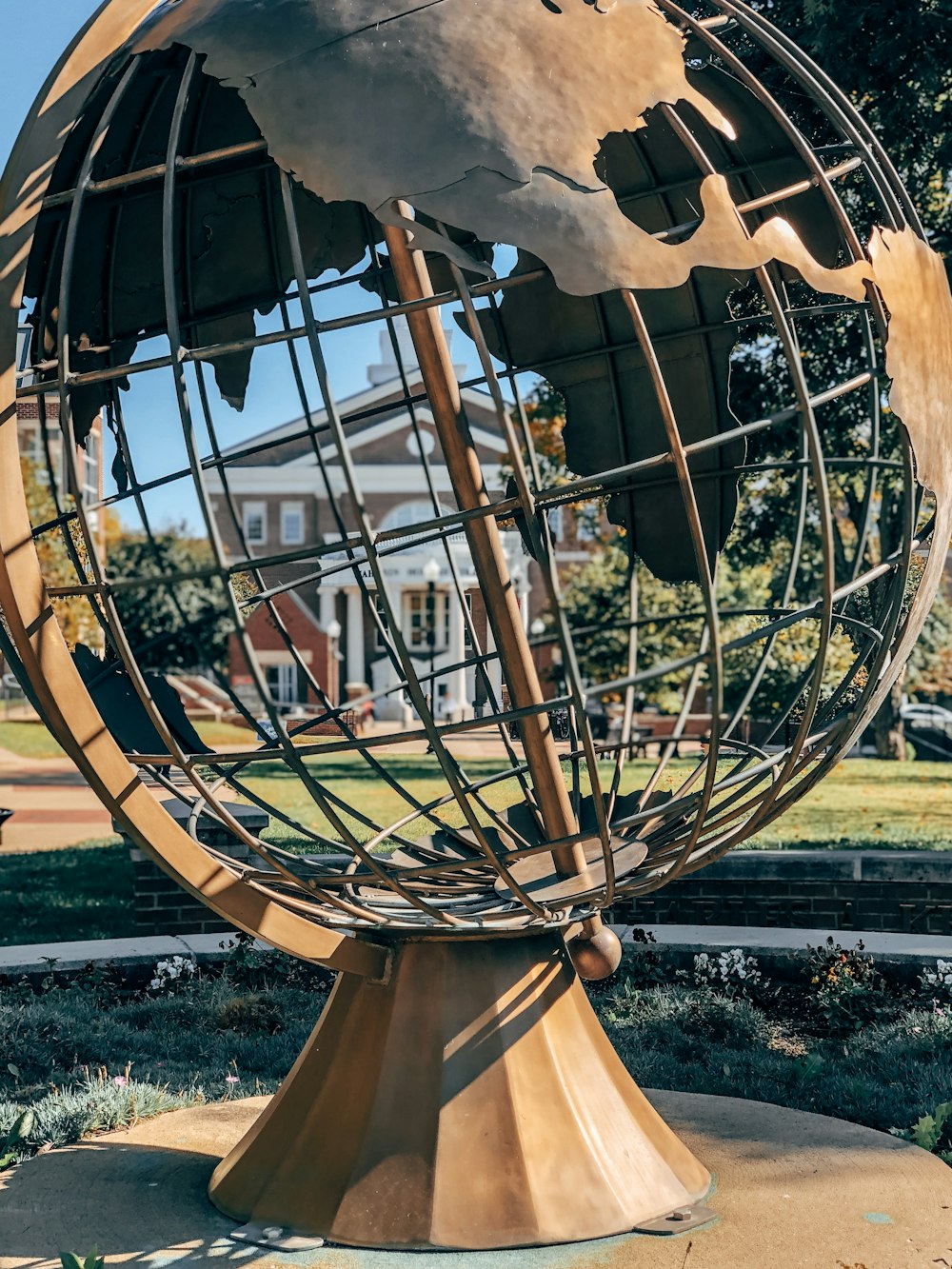 round gray metal globe statue