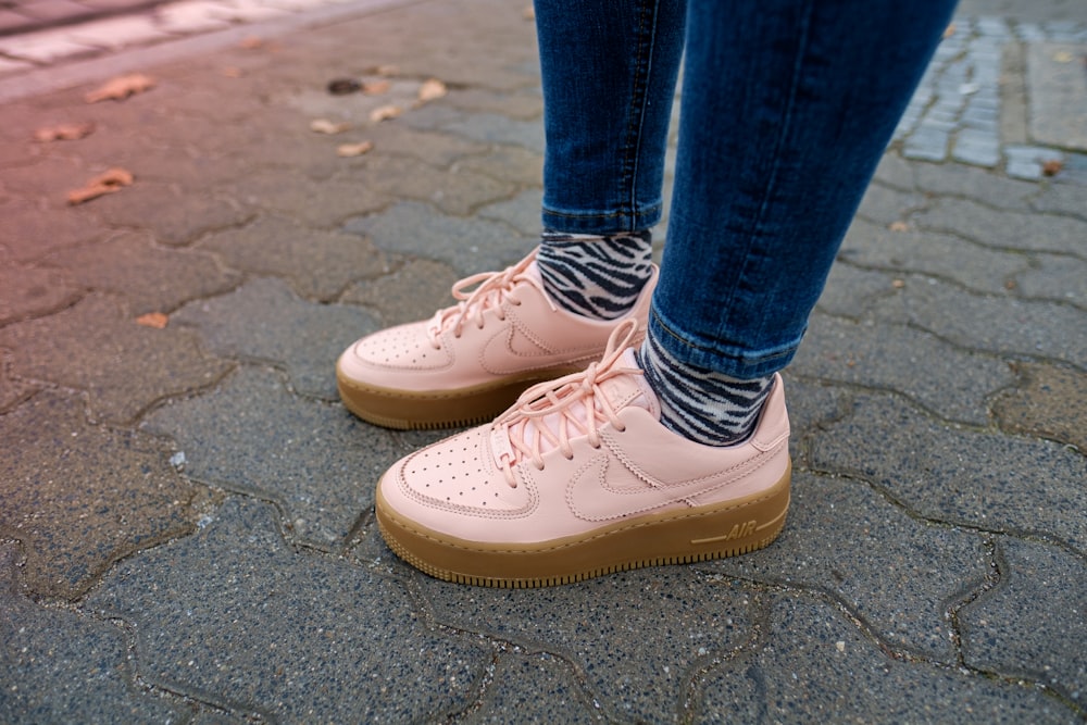 person wearing blue denim jeans and white Nike Air Force low-top sneakers  standing photo – Free Poland Image on Unsplash