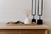 white ceramic vase near two black table decors