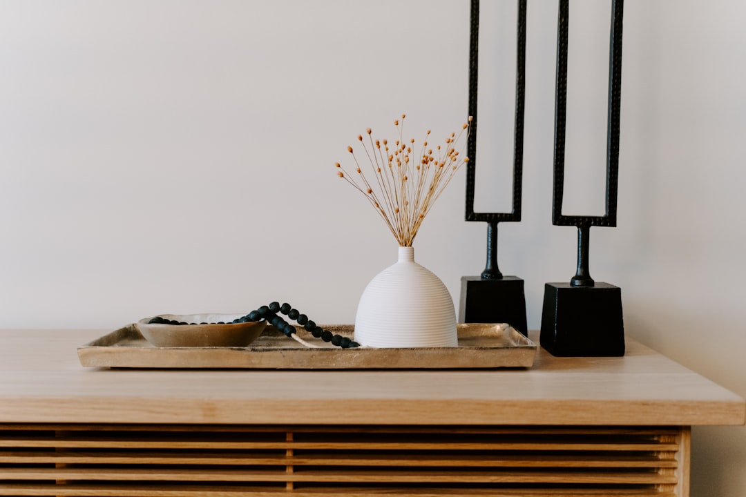 Home decoration pieces placed on top of wooden table.