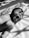 grayscale photo of baby on bed