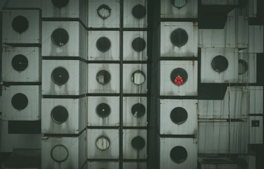 Close-up of a steel modular housing unit being assembled in a modern industrial factory.