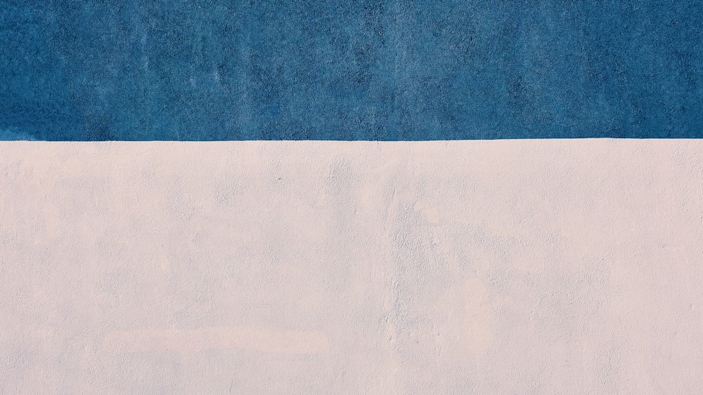 a painting of a blue and white wall