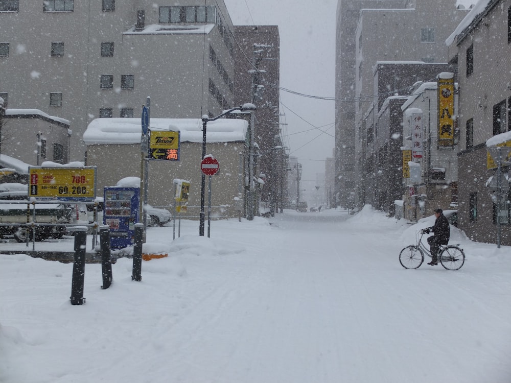 person riding bike at the city during winter